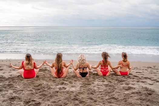 Big happy family or group of five friends is having fun against sunset beach. Beach holidays concept