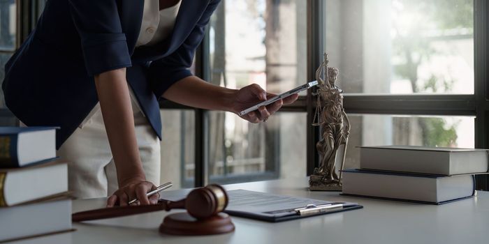 Close up of business lawyers working with agreement contract in office. Law, legal services, advice, Justice concept.