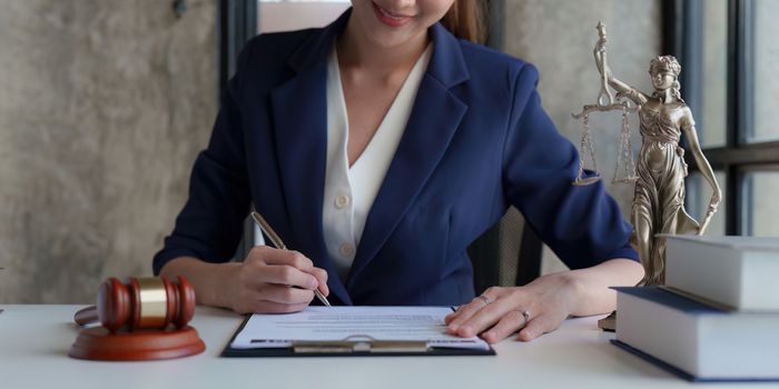 Close up of business lawyers working with agreement contract in office. Law, legal services, advice, Justice concept.