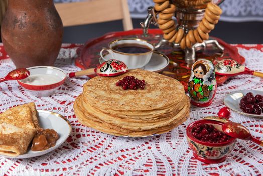 Russian pancake blini with berries and sour cream on the table. Shrovetide Maslenitsa festival concept. Top view. Flat lay
