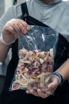 Pack of frozen seafood in hand
