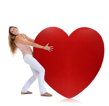Love, studio and woman pull heart isolated on a white background. Beauty, fashion and young female model pulling heavy symbol or sign for romance emoji, affection or romantic passion, care or empathy.