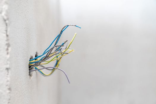 holes and wires in the wall for sockets and switches. High quality photo