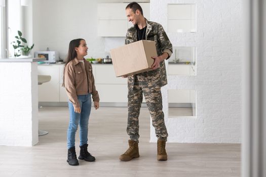 Soldier Holding Shipping Box. military man with a box.