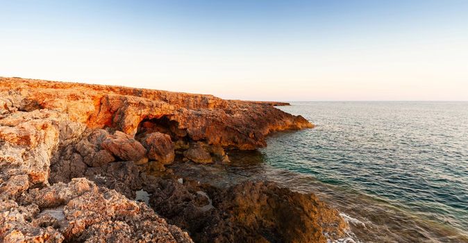 Rock coast of Lampedusa at sunset, Sicily