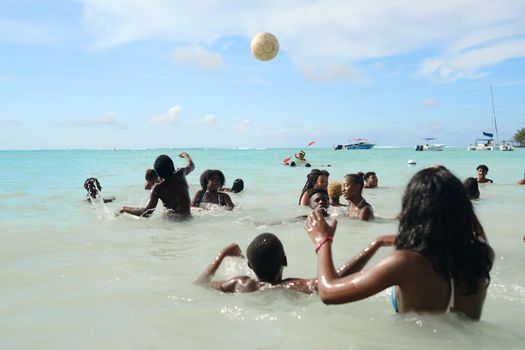 December 8, 2019 Mauritius Island, locals swim in the Indian Ocean and play with a ball.