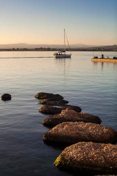 Rock on the sea at sunset in Ortigia, Syracuse