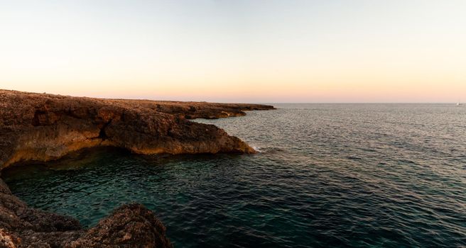 Rock coast of Lampedusa at sunset, Sicily
