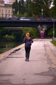 VIENNA, AUSTRIA - MAY, 22: Woman jogging next to the Donaukanal river on May 22, 2018