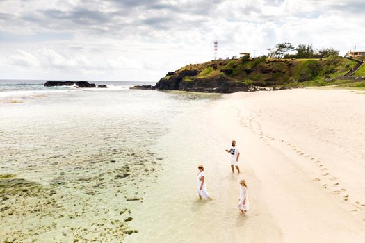 A family walks on Gris Gris beach in southern Mauritius in the Indian Ocean.