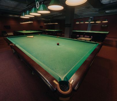 Billiard table with green surface and balls in the billiard club.Pool Game.
