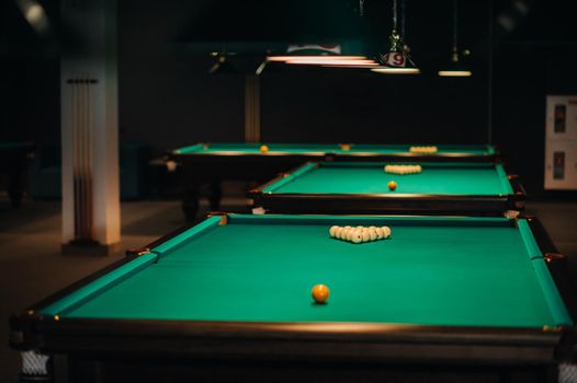 Billiard table with green surface and balls in the billiard club