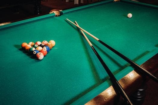 Billiard table with green surface and balls in the billiard club.Pool Game.