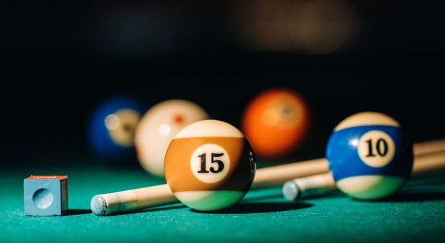 Billiard table with green surface and balls in the billiard club.Pool Game.