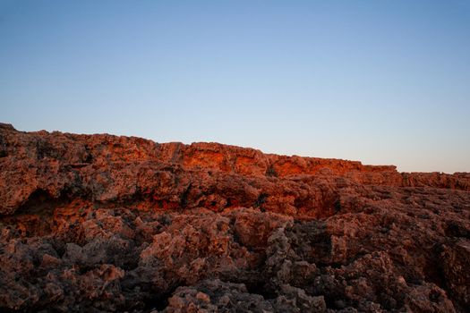 Rock coast of Lampedusa at sunset, Sicily