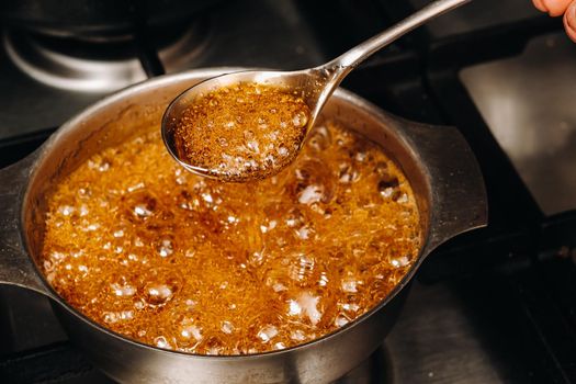 Preparation of sugar candies at home.A taste of our childhood.Rooster lollipops.Boiling Sugar caramel.