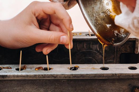 Making sugar lollipops at home.A taste of our childhood.Cockerel lollipops on a stick.Sugar caramel.