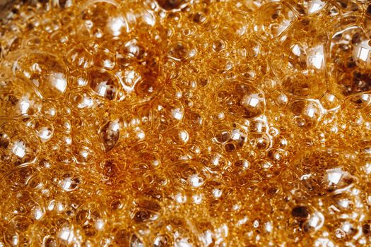 Preparation of sugar candies at home.A taste of our childhood.Background, sugar bubbles Texture.Boiling caramel sugar.
