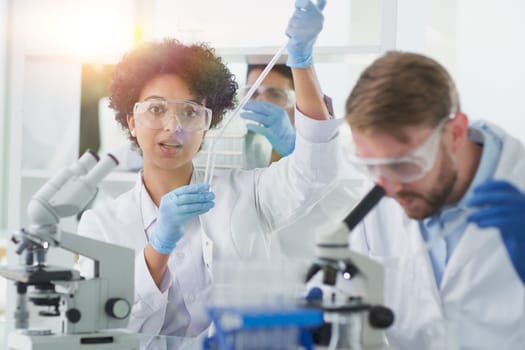 Team of Scientists Working Using Microscope, Analysing Microbiology Samples