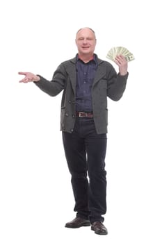 in full growth. happy casual man with dollar bills .isolated on a white background.