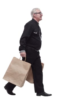 casual man with shopping bags striding forward. isolated on a white background.