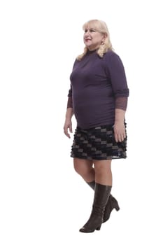 in full growth. casual mature woman stepping forward . isolated on a white background.