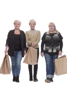 in full growth. three happy women with shopping bags. isolated on a white background.