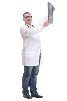 Side view of attractive doctor examining an x-ray and looking at the camera with positive
