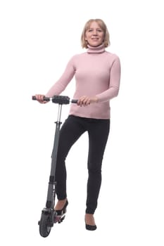 Full length portrait of a woman riding a scooter isolated on white background