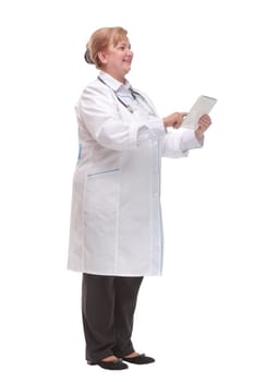 Side view of a middle age smiling doctor using a tablet computer - isolated over a white background