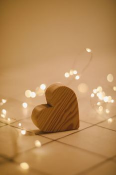 Valentines Day, Wedding concept - Wooden Heart by defocused blurred lights.