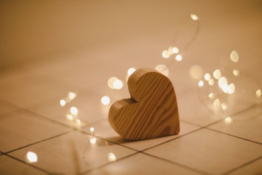 Valentines Day, Wedding concept - Wooden Heart by defocused blurred lights.