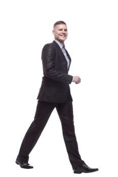 in full growth. young businessman confidently striding forward. isolated on a white background.