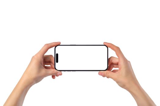 Phone in hand on a white background. A woman's hand holds a new modern phone in her hand on a white background with a blank white screen