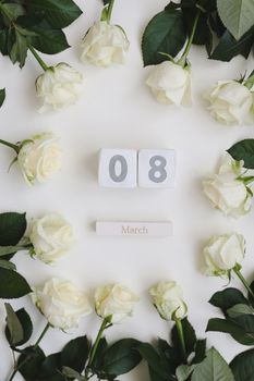 8 March, Woman Day background with white roses and place for text on white background top view.