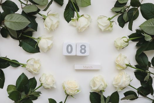 8 March, Woman Day background with white roses and place for text on white background top view.