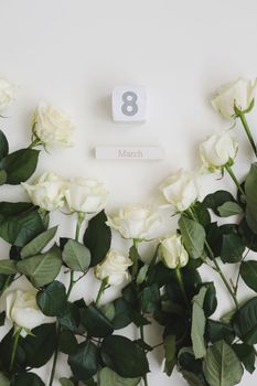 8 March, Woman Day background with white roses and place for text on white background top view.