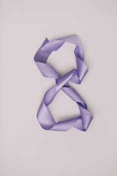 Eight made of violet ribbon. 8 March greeting card template. International Women's day background, banner, poster or brochure.