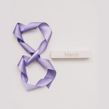 Eight made of violet ribbon. 8 March greeting card template. International Women's day background, banner, poster or brochure.