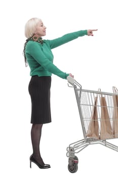 in full growth. smiling woman with a shopping cart. isolated on a white background.