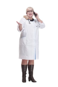 in full growth. attending doctor using her smartphone. isolated on a white background.
