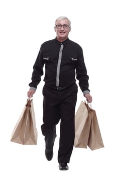 casual man with shopping bags striding forward. isolated on a white background.