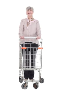 in full growth. smiling old lady with a shopping cart . isolated on a white background.