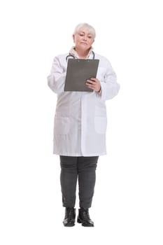 Happy mature doctor with stethoscope writing on clipboard, isolated over white background