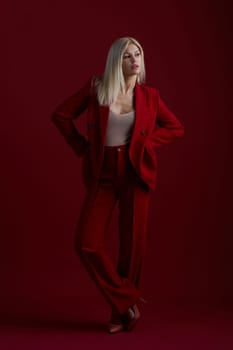 Portrait of a blonde woman in red dress on a red background