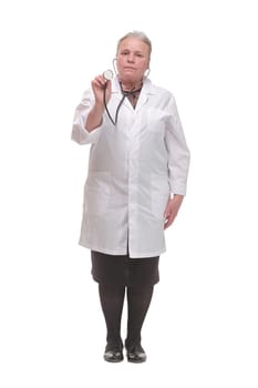 A female doctor with a stethoscope listening and looking at camera, isolated on white background