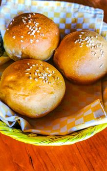 Delicious round buns with sesame seeds on wooden table in El Cafecito in Zicatela Puerto Escondido Mexico.