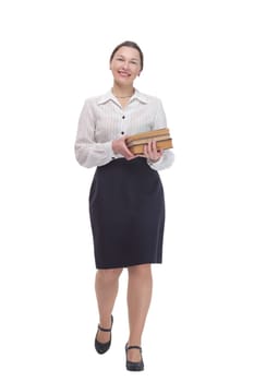 in full growth. businesswoman with a stack of books. isolated on a white background.