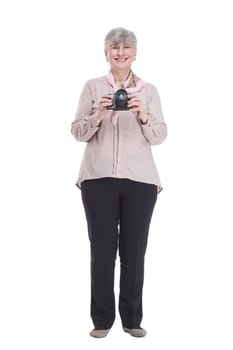in full growth. happy old lady with a camera in her hands. isolated on a white background.