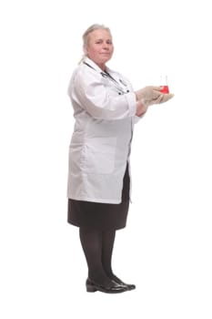 Side view of a mature scientist studying the red iquid in the beaker. Concept of scientific research